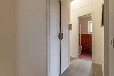 a hallway with a door leading to a bathroom at GuestHost - Colosseo & San Clemente Apartment in Rome
