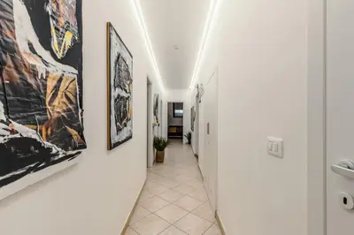 a hallway with art hanging on the walls at Domus Christina in Rome