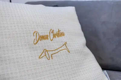 a pillow with the word dance on it sitting on a couch at Domus Christina in Rome