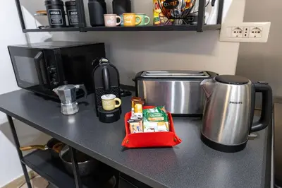a counter top with a coffee maker and a microwave at Domus Christina in Rome