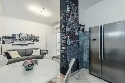 a living room with a table and a refrigerator at Domus Christina in Rome