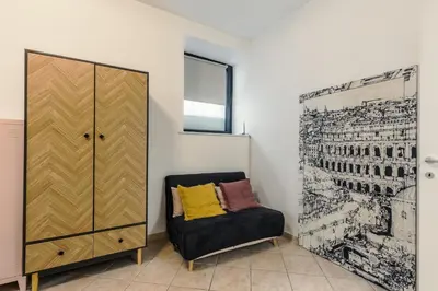 a room with a chair next to a cabinet at Domus Christina in Rome