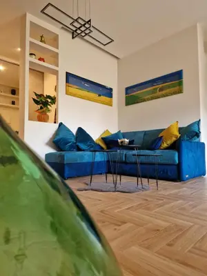 a living room with a blue couch and a table at Vacanze Romane Apartments - Vatican City in Rome