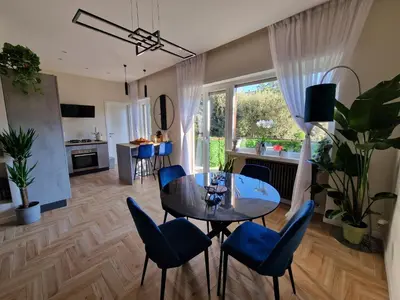 a living room with a dining room table and chairs at Vacanze Romane Apartments - Vatican City in Rome
