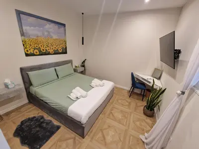 a bedroom with a bed and a painting on the wall at Vacanze Romane Apartments - Vatican City in Rome