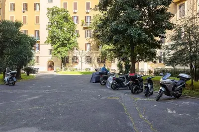 a row of motorcycles parked in front of a building at WMR Apartment near Vatican in Rome