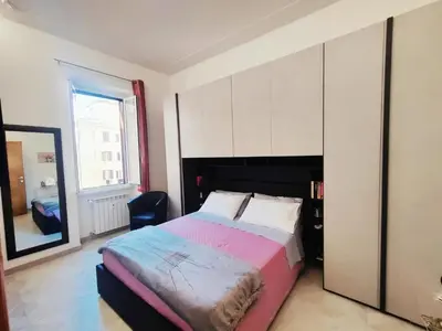 a bedroom with a large bed and a mirror at Portami a Roma in Rome