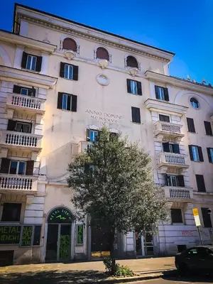 a large white building with a tree in front of it at Portami a Roma in Rome