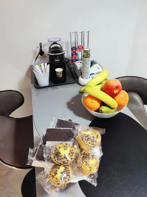 a table with a bowl of fruit and a plate of bagels at Portami a Roma in Rome