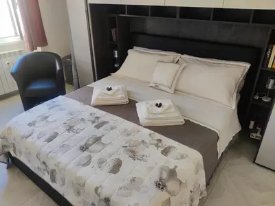 a bedroom with a bed with two towels on it at Portami a Roma in Rome