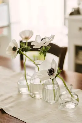 a vase with flowers in it on a table at Casa Riva 1920 in Rome