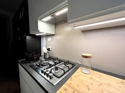 a kitchen with a stove and a counter top at La Casa del giornalista - ItalyHolidayHouse in Rome
