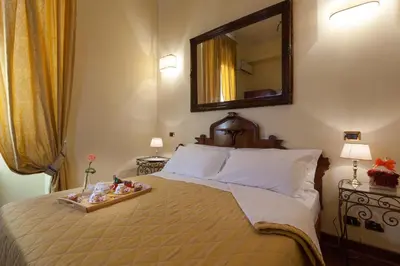 a bedroom with a bed with a tray of toys on it at Vatican Domus in Rome