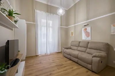 a living room with a couch and a television at Casa Pallini Luxury Apartment in Rome