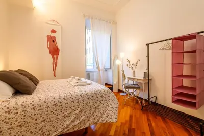 a bedroom with a bed and a dresser at Suite Apartment Prati in Rome