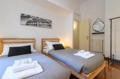 a bedroom with two beds with towels on them at Suite Apartment Prati in Rome