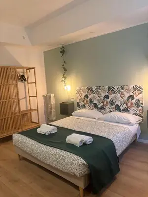 a bedroom with a bed with two towels on it at corso francia suite in Rome