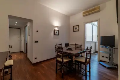a dining room with a table and chairs and a television at GuestHost - A due passi da Santa Maria Maggiore Apartment in Rome