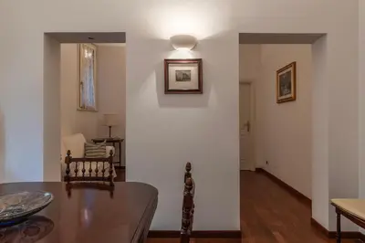 a dining room with a table and a room with a hallway at GuestHost - A due passi da Santa Maria Maggiore Apartment in Rome