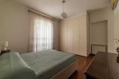 a bedroom with a bed and a large window at GuestHost - A due passi da Santa Maria Maggiore Apartment in Rome