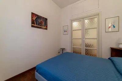 a bedroom with a blue bed and a window at GuestHost - A due passi da Santa Maria Maggiore Apartment in Rome