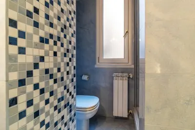a bathroom with a toilet and a window at GuestHost - A due passi da Santa Maria Maggiore Apartment in Rome