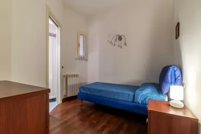 a living room with a blue couch in a room at GuestHost - A due passi da Santa Maria Maggiore Apartment in Rome