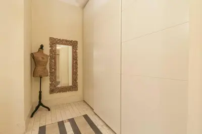 a dressing room with a mirror on a wall at BORGO PIO - quite and spacious apt in Rome