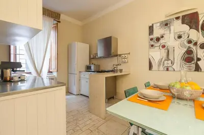 a kitchen with a counter top and a refrigerator at BORGO PIO - quite and spacious apt in Rome