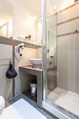 a bathroom with a sink and a shower with hearts on the floor at Relais 155 Guest House in Rome