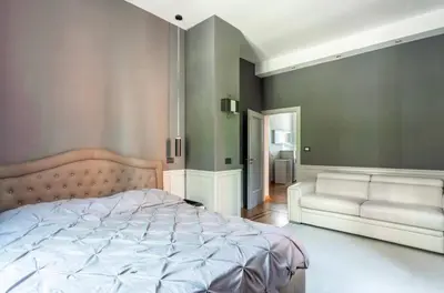 a bedroom with a large bed and a couch at Vatican Home 51 in Rome