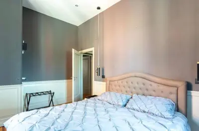 a bedroom with a large bed with a blue comforter at Vatican Home 51 in Rome