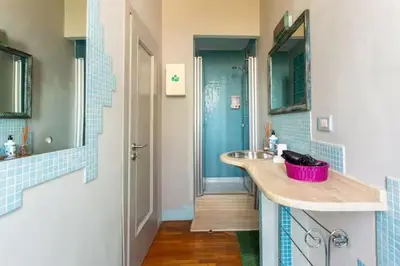 a bathroom with a sink with a pink basket at Vatican Home 51 in Rome