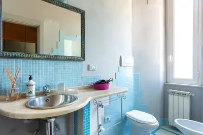 a bathroom with a sink and a toilet and a mirror at Vatican Home 51 in Rome