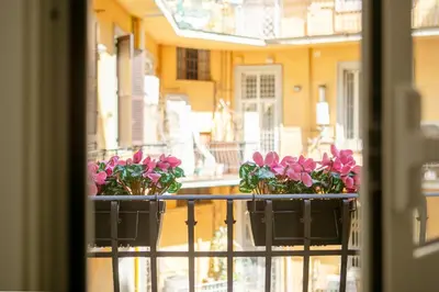 two flower pots on a balcony with pink flowers at Parisi apt in Rome