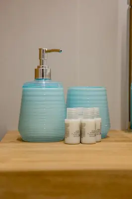 a sink with a faucet and three containers on a counter at Parisi apt in Rome