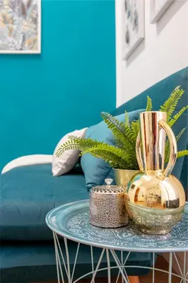 a coffee table with a gold vase on it at Parisi apt in Rome