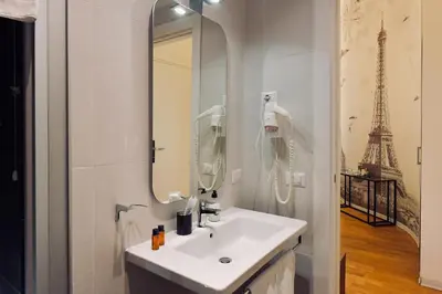a bathroom with a toilet and a sink at Suites Farnese Design in Rome