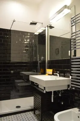 a bathroom with a white sink and a mirror at Leoncino 36 Apartments in Rome in Rome