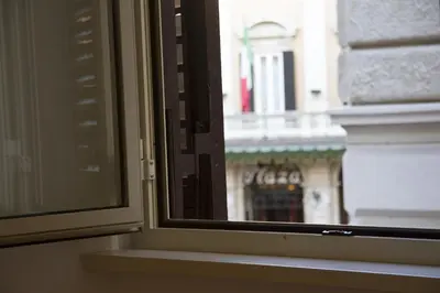 a window with a view of a building at Leoncino 36 Apartments in Rome in Rome