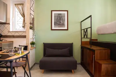 a living room with a chair and a table at Ton Ton by Ghor in Rome
