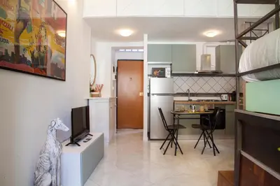 a living room with a tv and a kitchen at Ton Ton by Ghor in Rome