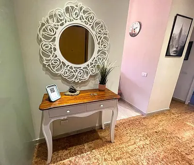 a dressing table with a mirror on a wall at La Casa Libre Metro A Colli Albani 350 m in Rome