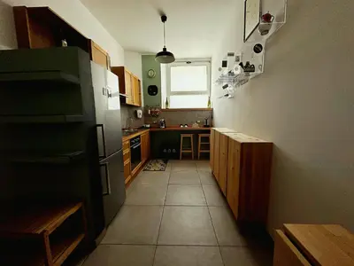 a kitchen with a refrigerator and a tile floor at San Giovanni Apartment in Rome