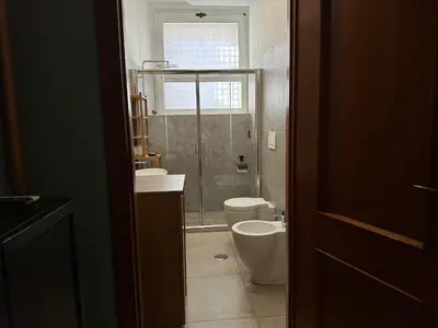 a bathroom with a shower and a toilet and a sink at San Giovanni Apartment in Rome