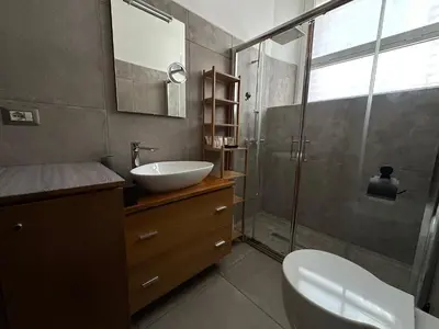 a bathroom with a sink and a toilet and a shower at San Giovanni Apartment in Rome