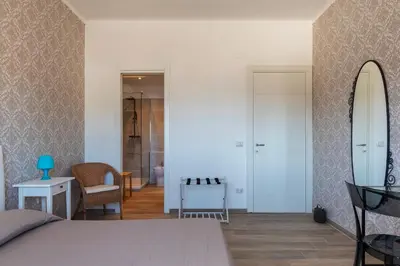 a bedroom with a bed and a surfboard on a wall at GuestHost - Valle Aurelia Elegant Apartment in Rome