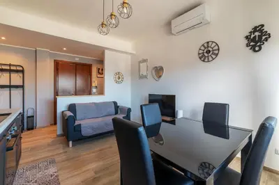 a living room with a desk and a couch at GuestHost - Valle Aurelia Elegant Apartment in Rome
