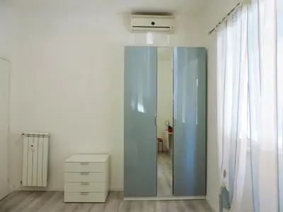 a room with a glass cabinet and a dresser at Kalu apartment in Rome