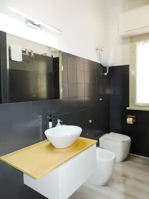 a bathroom with a sink and a toilet at Kalu apartment in Rome